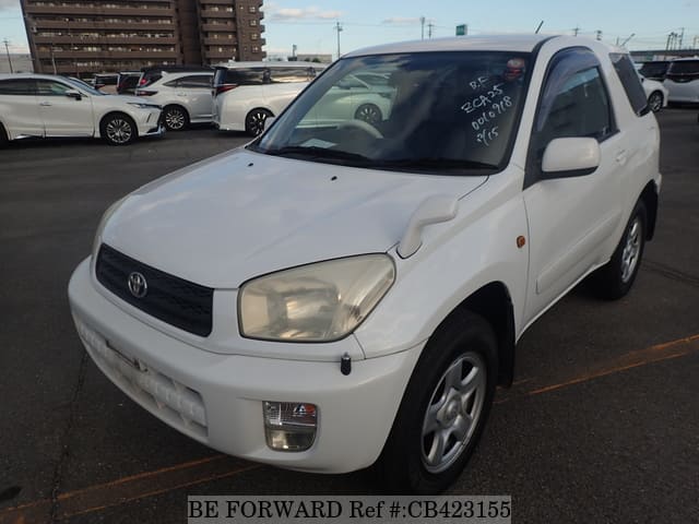 A grey JDM sports car speeding down a highway at night.