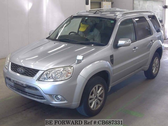 A grey JDM sports car speeding down a highway at night.