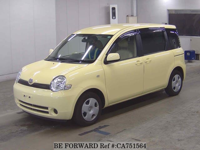 A grey JDM sports car speeding down a highway at night.