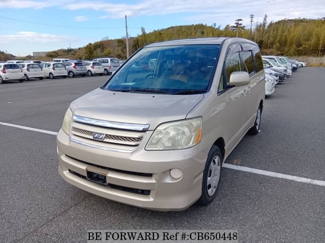 A grey JDM sports car speeding down a highway at night.