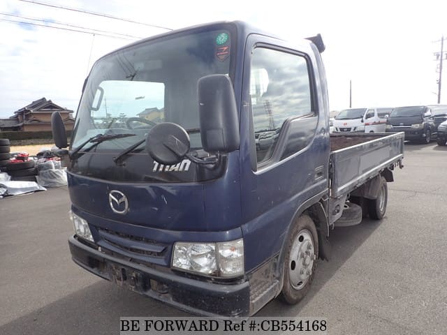 A grey JDM sports car speeding down a highway at night.