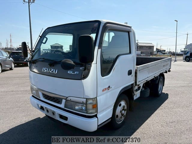 A grey JDM sports car speeding down a highway at night.