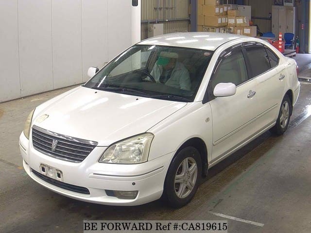 A grey JDM sports car speeding down a highway at night.