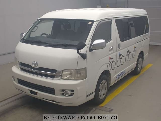 A grey JDM sports car speeding down a highway at night.