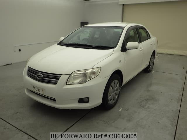 A grey JDM sports car speeding down a highway at night.