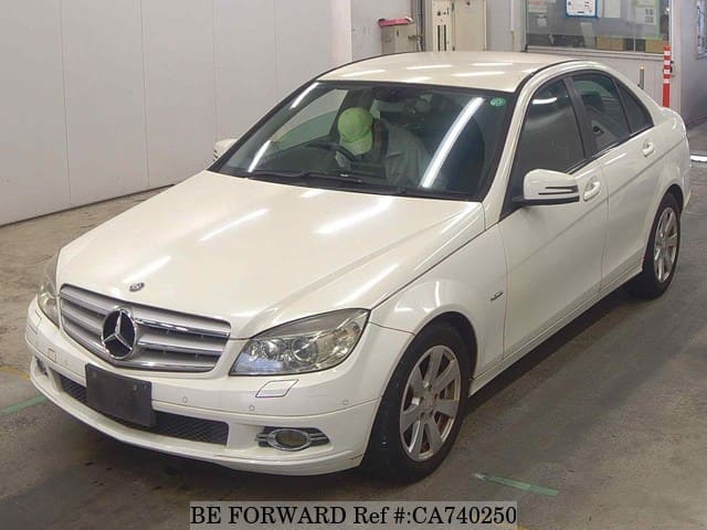 A grey JDM sports car speeding down a highway at night.