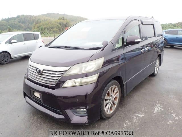 A grey JDM sports car speeding down a highway at night.