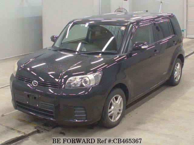 A grey JDM sports car speeding down a highway at night.