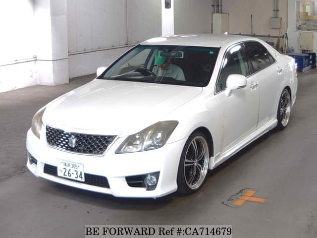 A grey JDM sports car speeding down a highway at night.