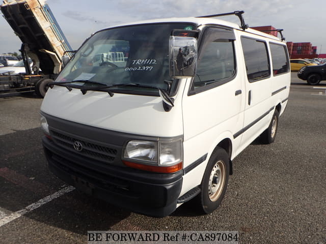A grey JDM sports car speeding down a highway at night.