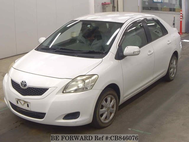 A grey JDM sports car speeding down a highway at night.