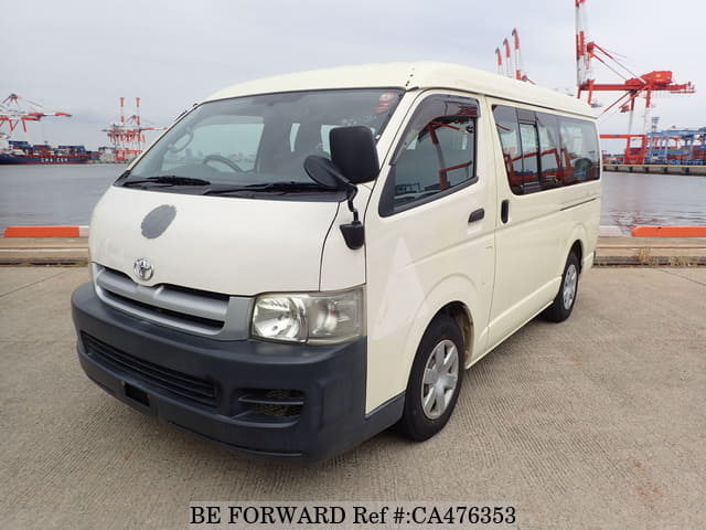 A grey JDM sports car speeding down a highway at night.