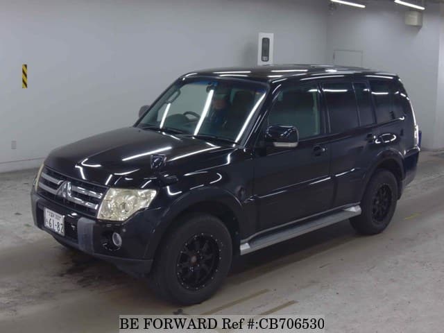 A grey JDM sports car speeding down a highway at night.