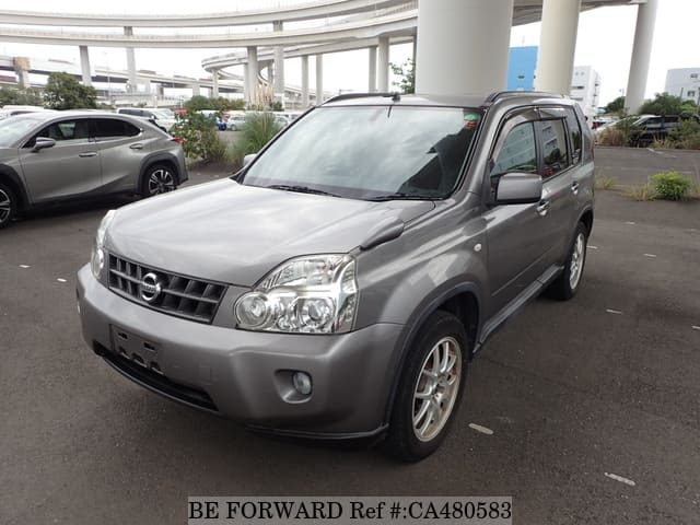 A grey JDM sports car speeding down a highway at night.