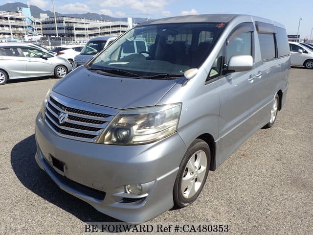 A grey JDM sports car speeding down a highway at night.