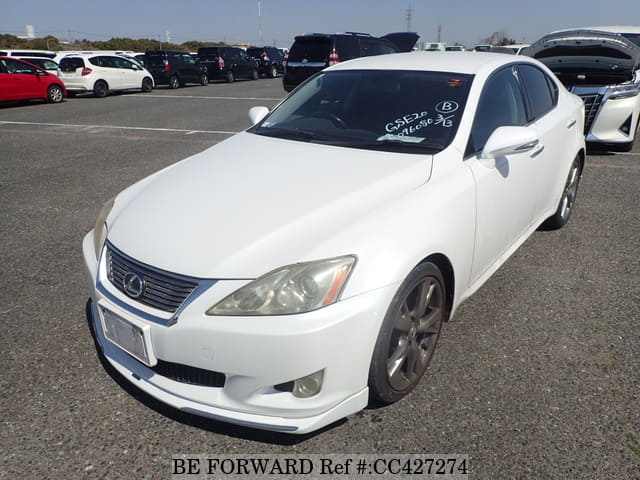 A grey JDM sports car speeding down a highway at night.