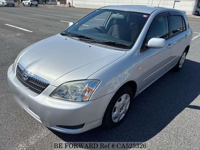 A grey JDM sports car speeding down a highway at night.