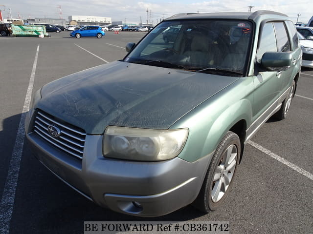 A grey JDM sports car speeding down a highway at night.