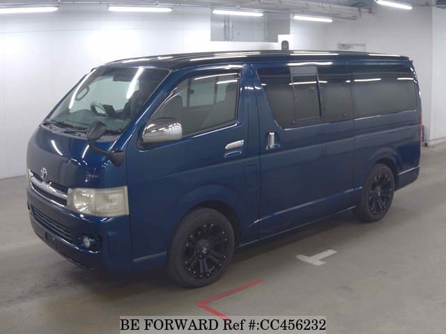 A grey JDM sports car speeding down a highway at night.