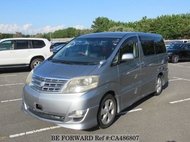 A grey JDM sports car speeding down a highway at night.