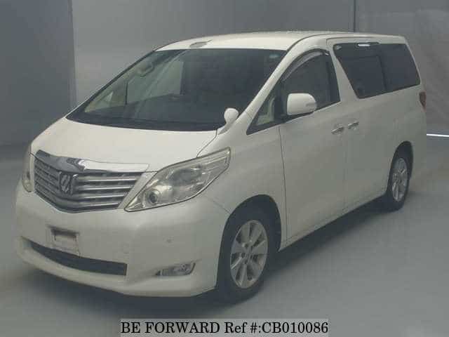 A grey JDM sports car speeding down a highway at night.