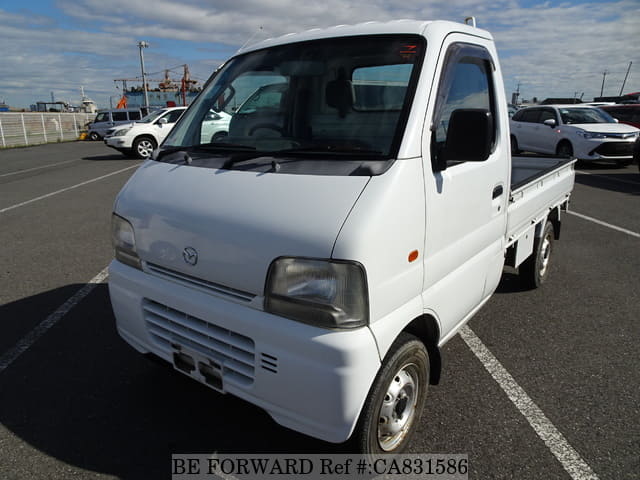 A grey JDM sports car speeding down a highway at night.