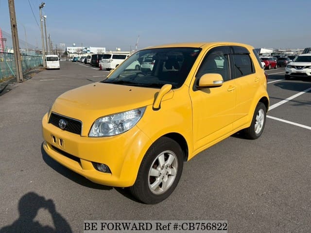 A grey JDM sports car speeding down a highway at night.