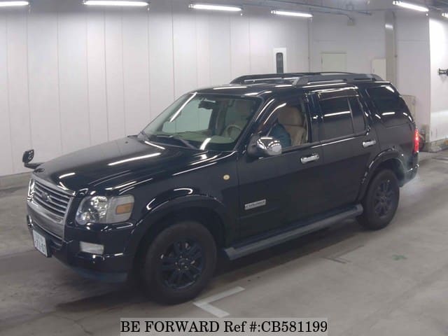 A grey JDM sports car speeding down a highway at night.