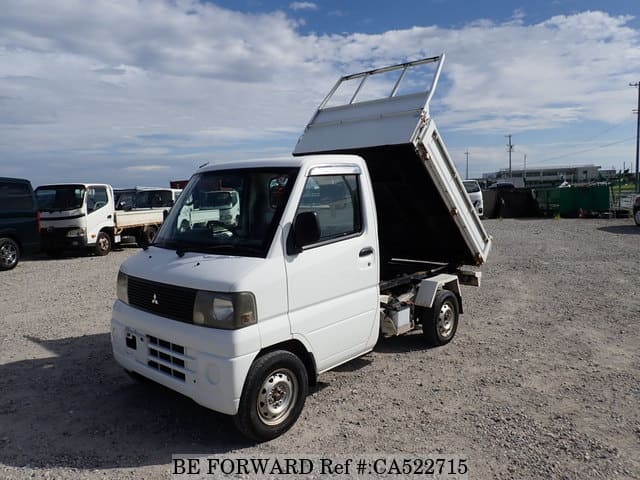 A grey JDM sports car speeding down a highway at night.