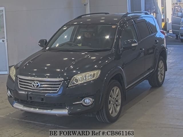 A grey JDM sports car speeding down a highway at night.