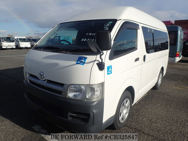 A grey JDM sports car speeding down a highway at night.