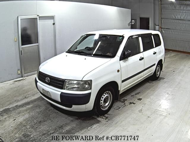 A grey JDM sports car speeding down a highway at night.