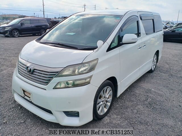 A grey JDM sports car speeding down a highway at night.