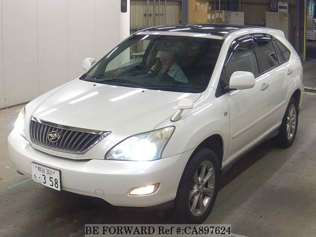 A grey JDM sports car speeding down a highway at night.