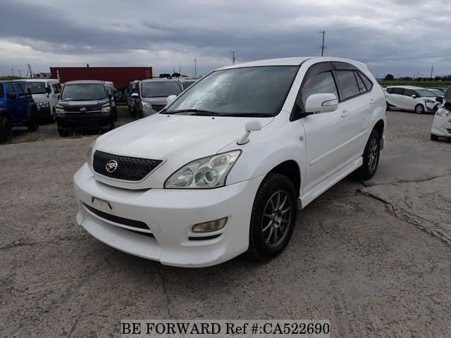 A grey JDM sports car speeding down a highway at night.