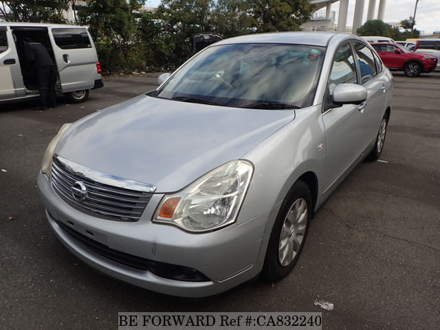 A grey JDM sports car speeding down a highway at night.