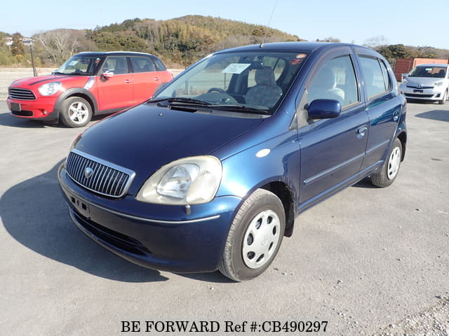 A grey JDM sports car speeding down a highway at night.