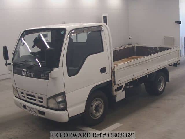 A grey JDM sports car speeding down a highway at night.