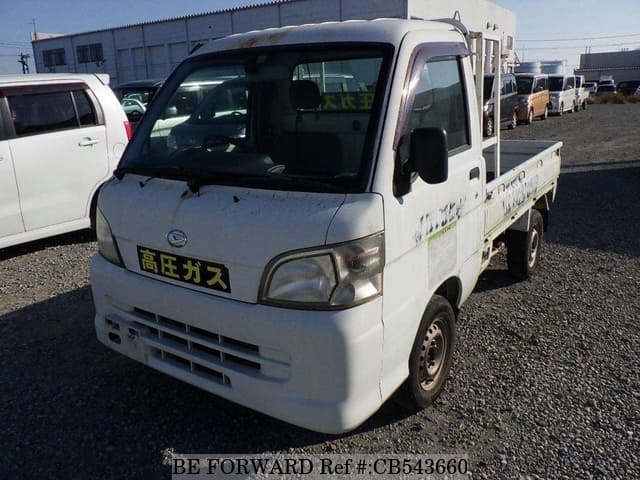 A grey sports car speeding down a highway at night.