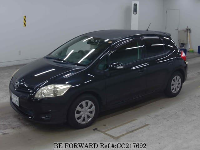 A grey sports car speeding down a highway at night.