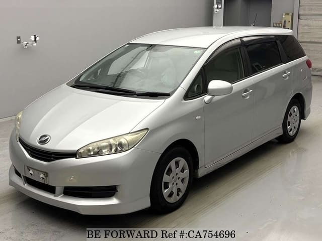 A grey JDM sports car speeding down a highway at night.