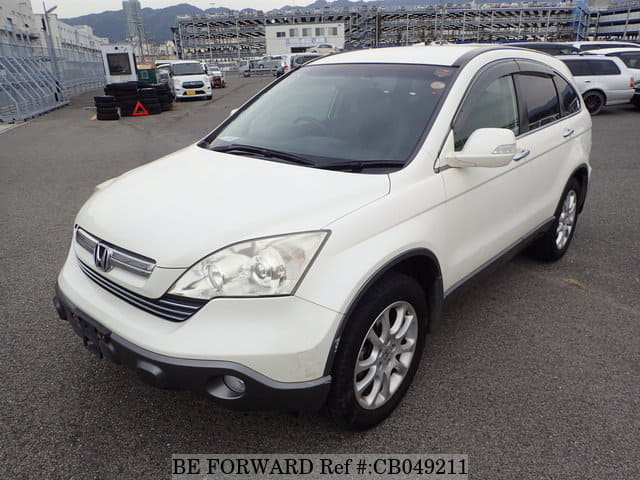 A grey JDM sports car speeding down a highway at night.