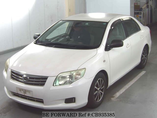 A grey sports car speeding down a highway at night.