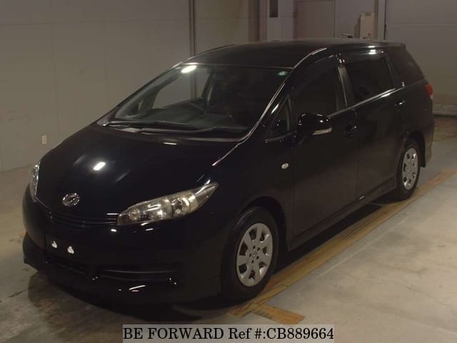 A grey JDM sports car speeding down a highway at night.