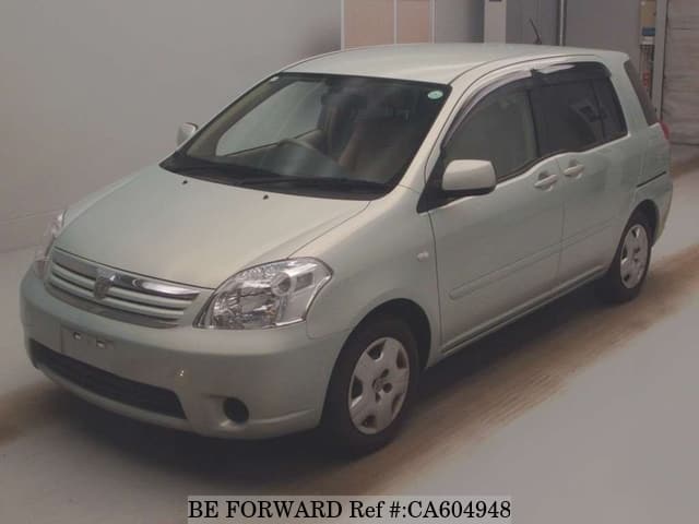 A grey JDM sports car speeding down a highway at night.