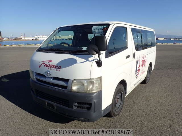 A grey JDM sports car speeding down a highway at night.