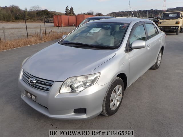 A grey JDM sports car speeding down a highway at night.