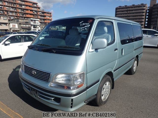 A grey JDM sports car speeding down a highway at night.