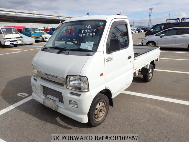 A grey JDM sports car speeding down a highway at night.