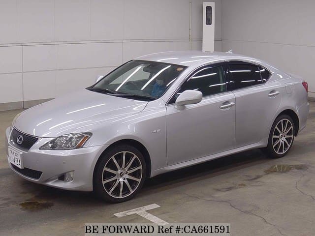 A grey JDM sports car speeding down a highway at night.